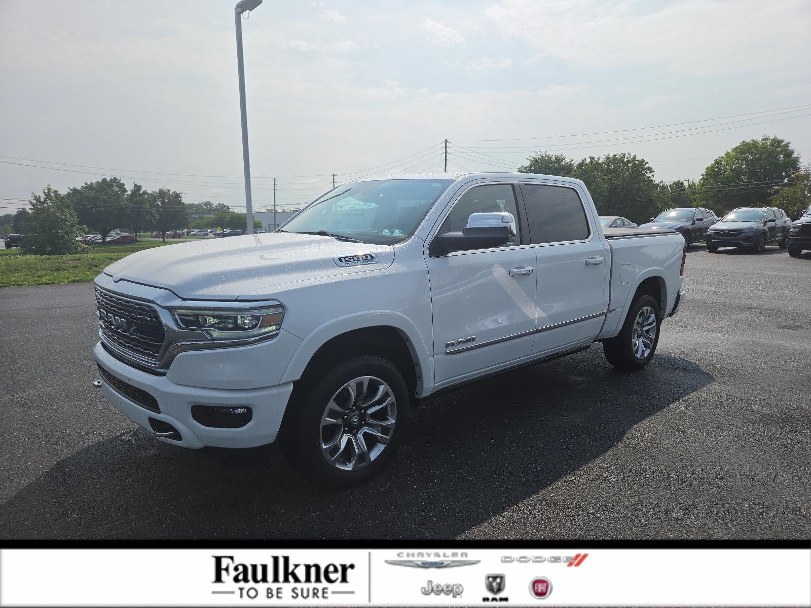 2023 RAM 1500 Limited 4x4 Crew Cab 5'7" Box in Bright White Clearcoat — front three-quarter view
