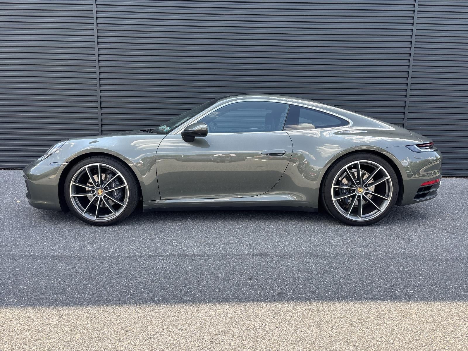 2023 Porsche 911 Carrera Coupe in Aventurine Green Metallic — front three-quarter view